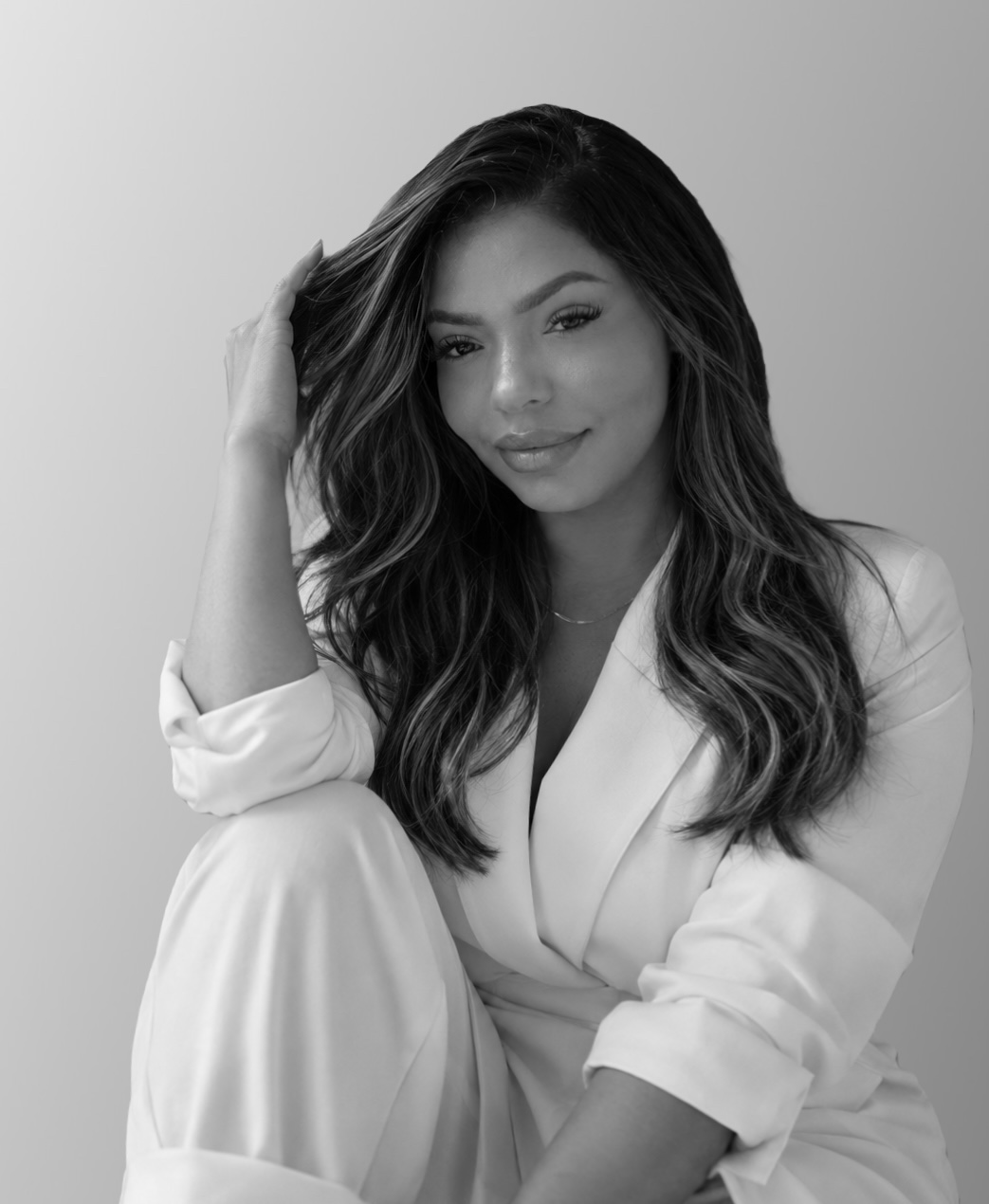 Arelis Santos in an elegant white suit